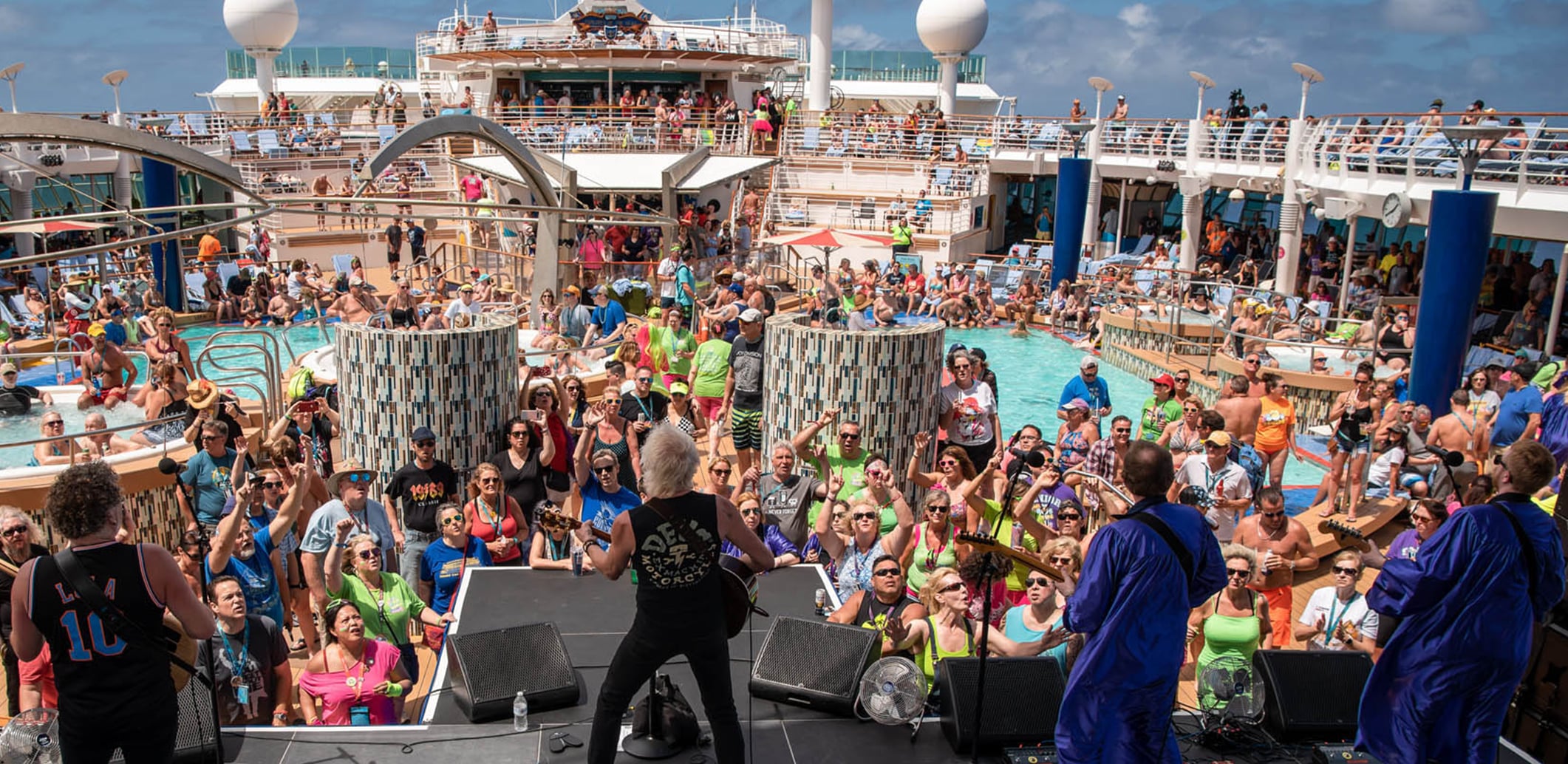 A performer onstage as cruise ship entertainment, booked by our talent booking services.